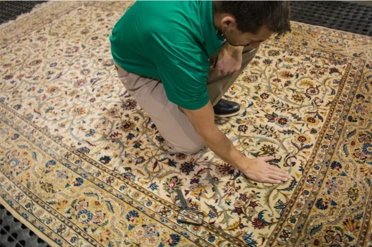 Chem-Dry technician inspecting a Persian-style area rug