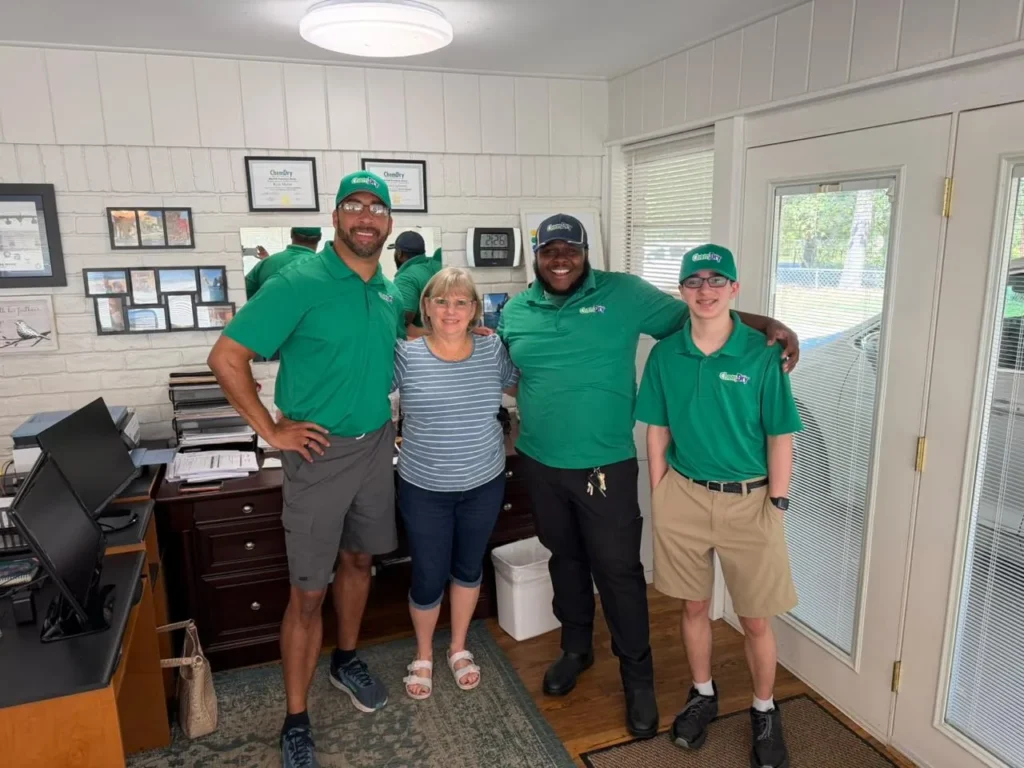 H-Town Chem-Dry carpet and upholstery cleaning team: three technicians in green Chem-Dry uniforms with a team member in the office